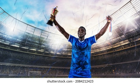 Soccer Player In Blue Uniform Rejoices For The Victory Of A Trophy At The Stadium