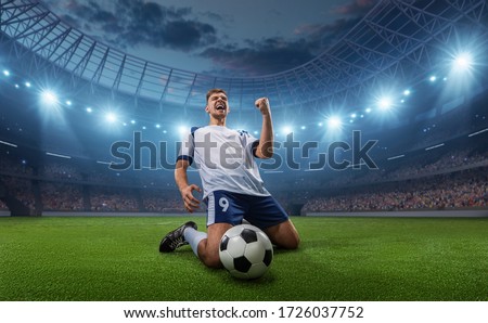 Soccer player celebrates a victory on the professional stadium . Stadium and crowd are made in 3D.
