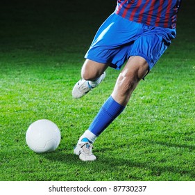 Soccer Player Doing Kick With Ball On Football Stadium  Field  Isolated On Black Background  In Night