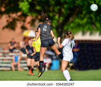 Soccer player heading the ball during a game - Powered by Shutterstock