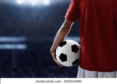 Soccer Player Holding Soccer Ball