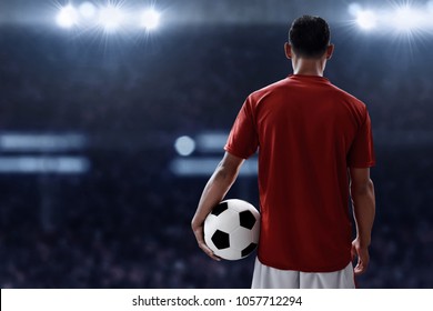 Soccer Player Holding Soccer Ball