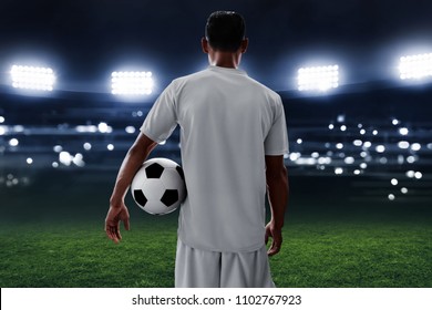 Soccer Player Holding Soccer Ball