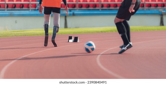 Soccer player kicking the ball on the track in the stadium with disabled athletes training sessions. - Powered by Shutterstock