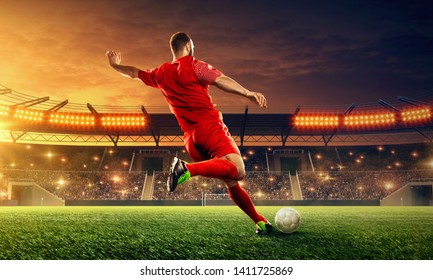 Soccer player kicks a ball. Action. Sports event. Night soccer stadium