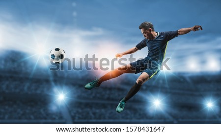Soccer player kicks the ball on the soccer field.Professional soccer player in action.