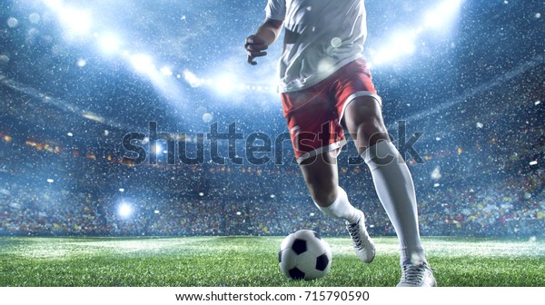 Soccer\
player kicks the ball on the soccer stadium. He wear unbranded\
sports clothes. Stadium and crowd made in\
3D.