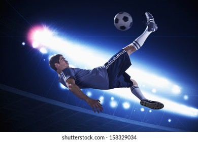 Soccer player in mid air kicking the soccer ball - Powered by Shutterstock