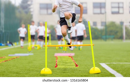 Soccer Player On Fitness Training. Footballers On Practice Session In Field On Sunny Day. Young Soccer Players At Speed And Agility Practice Training Session