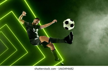 Soccer Player On Smoke Background. Green Neon Light.