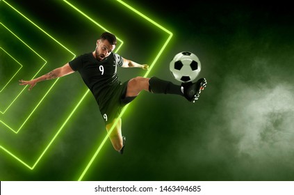 Soccer Player On Smoke Background. Green Neon Light.