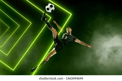 Soccer Player On Smoke Background. Green Neon Light.