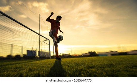 Soccer player playing football on stadium - Concept of sport, competition, motion, overcoming - Shutterstock ID 1885674775