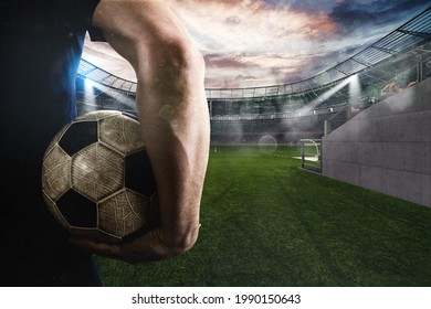 Soccer player ready to play with ball in his hand at the entrance of the football field