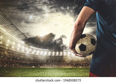 Soccer player ready to play or kick the ball in his hands at the stadium - Powered by Shutterstock