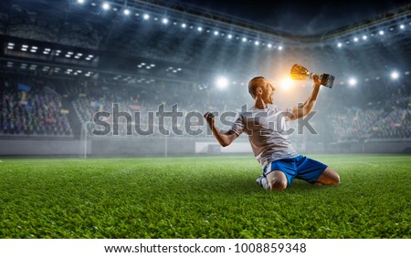 Soccer player at stadium. Mixed media