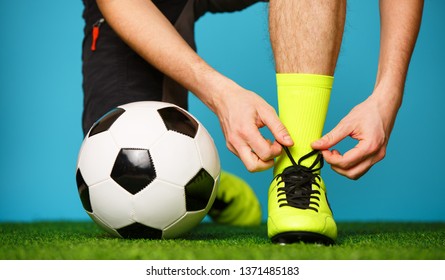 Soccer player tying his shoes - Powered by Shutterstock