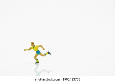 Soccer player with yellow jersey in shot position. Miniature people on white background - Shutterstock ID 1991413733