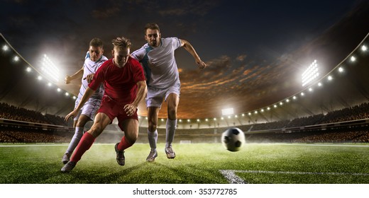 Soccer players in action on the sunset stadium background panorama - Powered by Shutterstock