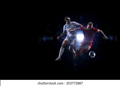 Soccer Players In Action Over Black Background