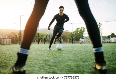 Soccer players during practice on football ground. Young footballer playing on the grass field. - Powered by Shutterstock