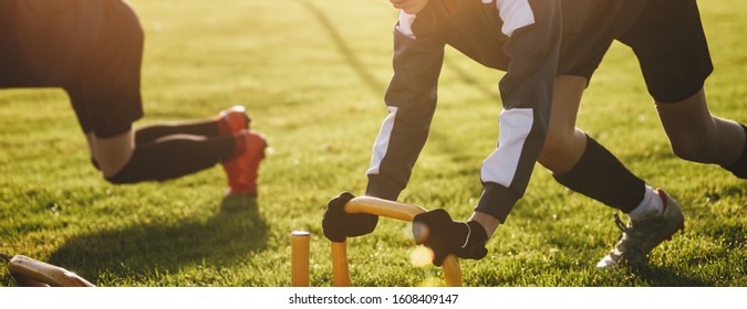 Soccer Players on Prowler Sled Training Outdoor. Youth Football Players on Practice in Sunny Day. Athletes Sled Training - Powered by Shutterstock