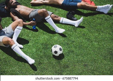 soccer players resting on football field after soccer match - Powered by Shutterstock