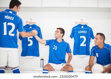 Soccer players shaking hands in locker room - Powered by Shutterstock