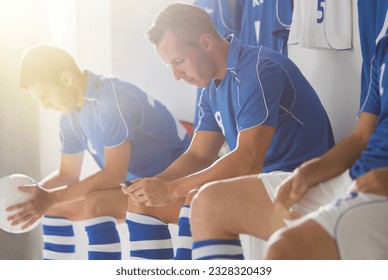 Soccer players sitting in locker room - Powered by Shutterstock