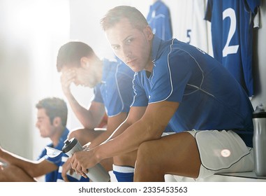 Soccer players sitting in locker room - Powered by Shutterstock