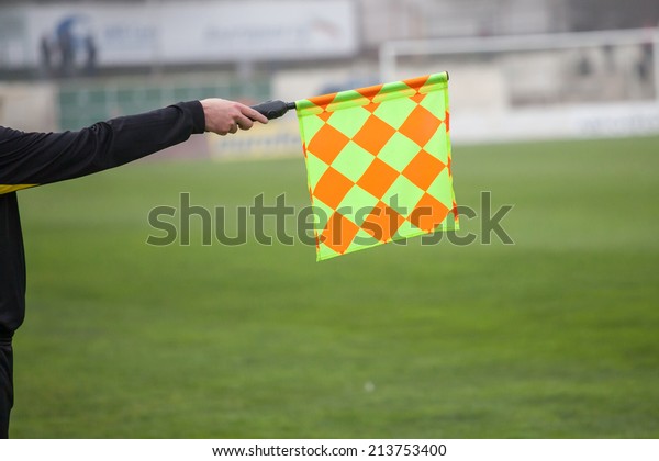 Soccer referee hold\
the flag. Offside trap