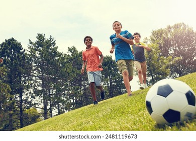 Soccer, running and boy children in park for game, bonding and fun outdoor holiday together. Sports, kids and happy friends playing on grass with smile, ball and energy on summer camp for football. - Powered by Shutterstock