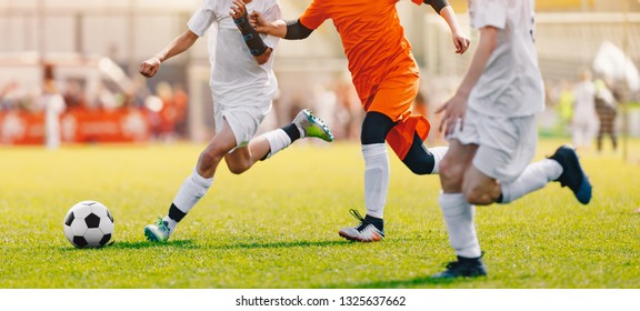 Soccer Shot. Young Boys Kicking Football Soccer Tournament Match On The Grass Pitch. Football Players Duel. Running Soccer Players From Youth School Soccer Teams