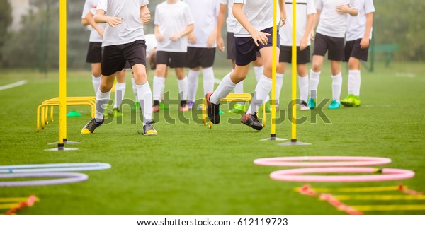 Soccer Skills Training\
Session. Players Training on the Field. Soccer Obstacle Course.\
Grass Football Field. Coaching Soccer Gear Equipment for Field\
Training