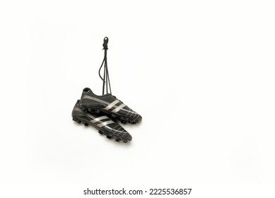 soccer spikes are hanging against white background