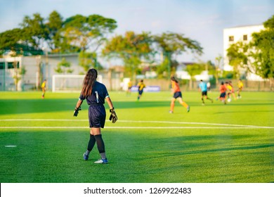 Soccer Sport Concept, Women Goal Keeper Standing On Field For Protect Other Player Team Shoot Ball To Goal. 