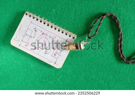 soccer tactics scribble on notepad and whistle of soccer referee or trainer. Great soccer event this year, soccer championship concept.