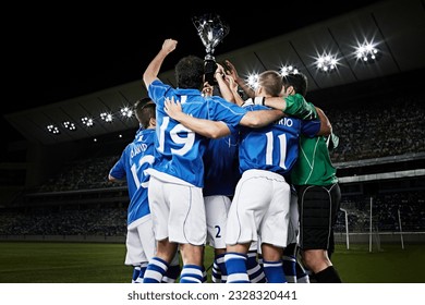 Soccer team cheering with trophy on field - Powered by Shutterstock