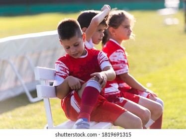 Soccer Team On The Sidelines Watching Game.