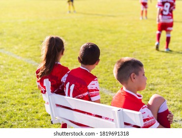 Soccer Team On The Sidelines Watching Game.