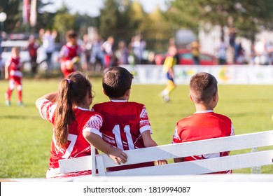 Soccer Team On The Sidelines Watching Game.