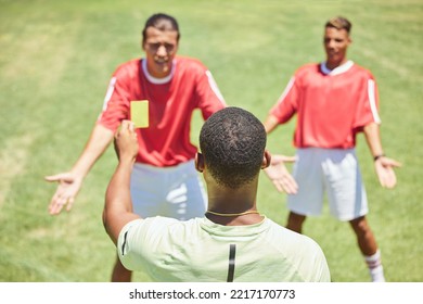 Soccer, Team And Referee With Yellow Card, Booking And Foul A Player On A Grass Pitch Or Field During A Game. Fitness, Football And Discipline With A Man Ref Giving A Caution During A Sports Match