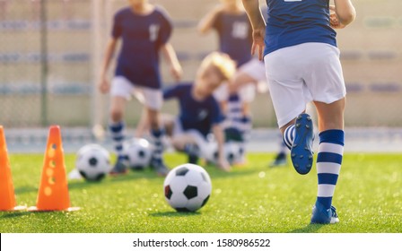 Soccer Training Practice. Player Running With Football Ball In Sports Grass Cleats. Training Session In Soccer For Youth Players. Kids On School Sports Venue