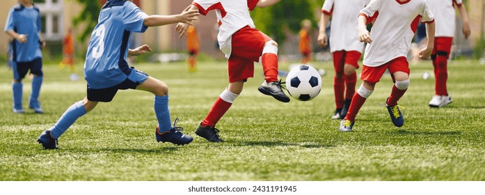 Soccer Youth Teams Play Outdoor Tournament. Young Soccer Players Competition. Boys Kicking Football Ball. Soccer Stadium in the Background - Powered by Shutterstock