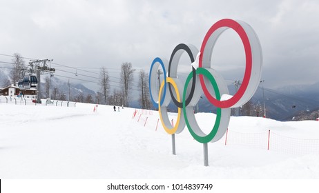 Sochi - March 29, 2017: Olympic rings at the ski resort of the Sochi Olympic Park in winter and people skiing away, March 29, 2017, Sochi, Russia