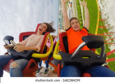 Sochi, Russia - 05.06.2019 Girl And Guy Ride On An Extreme Ride. High Speed. Fun. The Amusement Park. Sochi Park. Roller Coaster. 