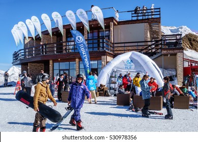 Sochi, Russia - February 13, 2014: Ski Slopes In Sochi Winter Mountain Resorts Can Host Ski And Snowboard Riders For 6 Months A Year. People Are Chilling Out By A Restaurant