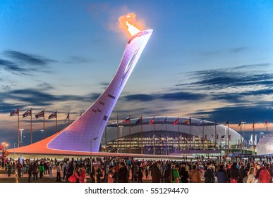 Sochi, Russia - February 15, 2014: The Olympic Torch erection with the burning flame in the Olympic Park was the main venue of the Sochi Winter Olympics in 2014. Beautiful scenic sunset landscape