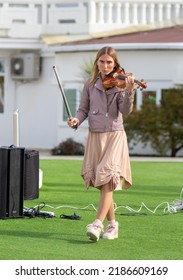 Sochi, Russia - February 22, 2022:A Woman Plays The Violin On The Street In A Resort Town.