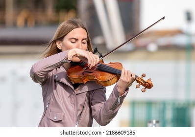 Sochi, Russia - February 22, 2022:A Woman Plays The Violin On The Street In A Resort Town.